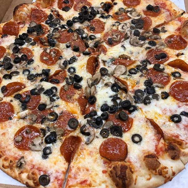 Pizza with pepperoni and olives from 828 Family Pizzeria in Asheville, NC