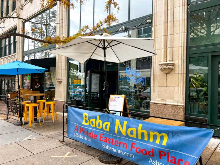 Exterior of Baba Nahm in downtown Asheville's Grove Arcade showing outdoor seating