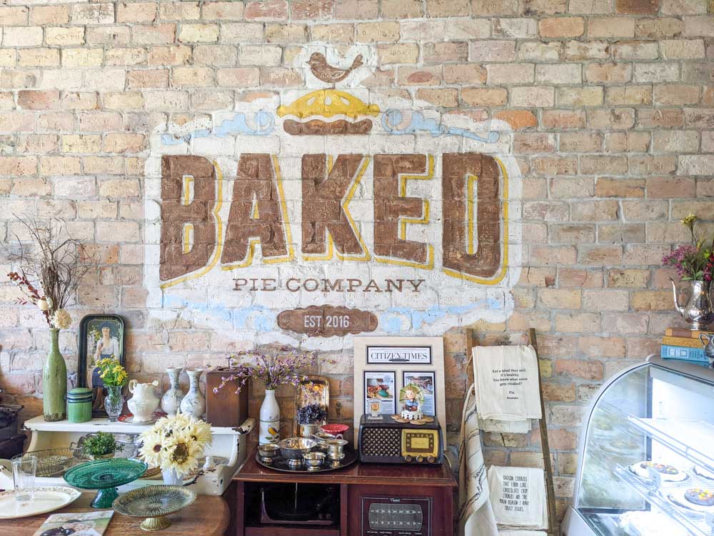 Baked Pie Company's logo painted on a brick wall