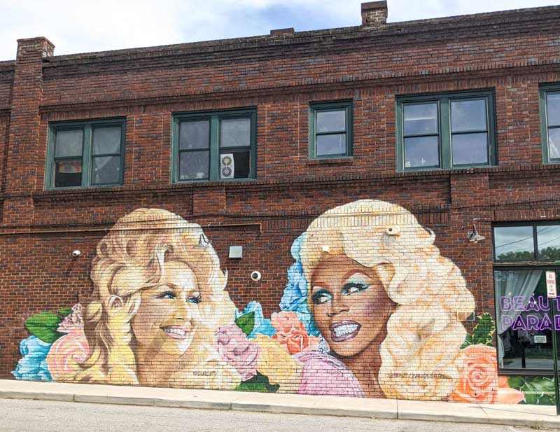 A mural of Dolly Parton and RuPaul in West Asheville