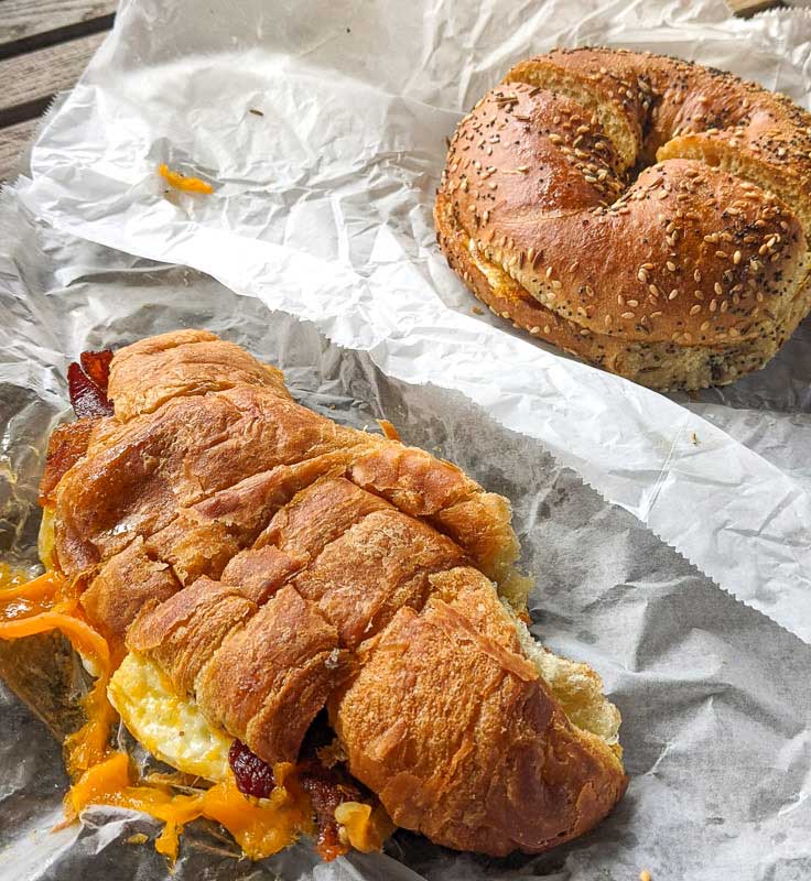 Croissant sandwich and bagel sandwich on bakery paper from Geraldine's