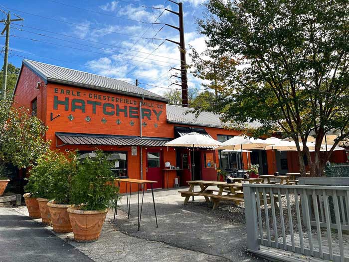 The Hatchery building in the River Arts District with picnic tables in front of it for Baby Bull customers