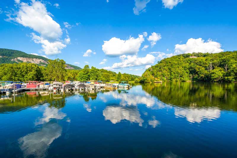 Lake Lure with boats on the water and mountains in the distance