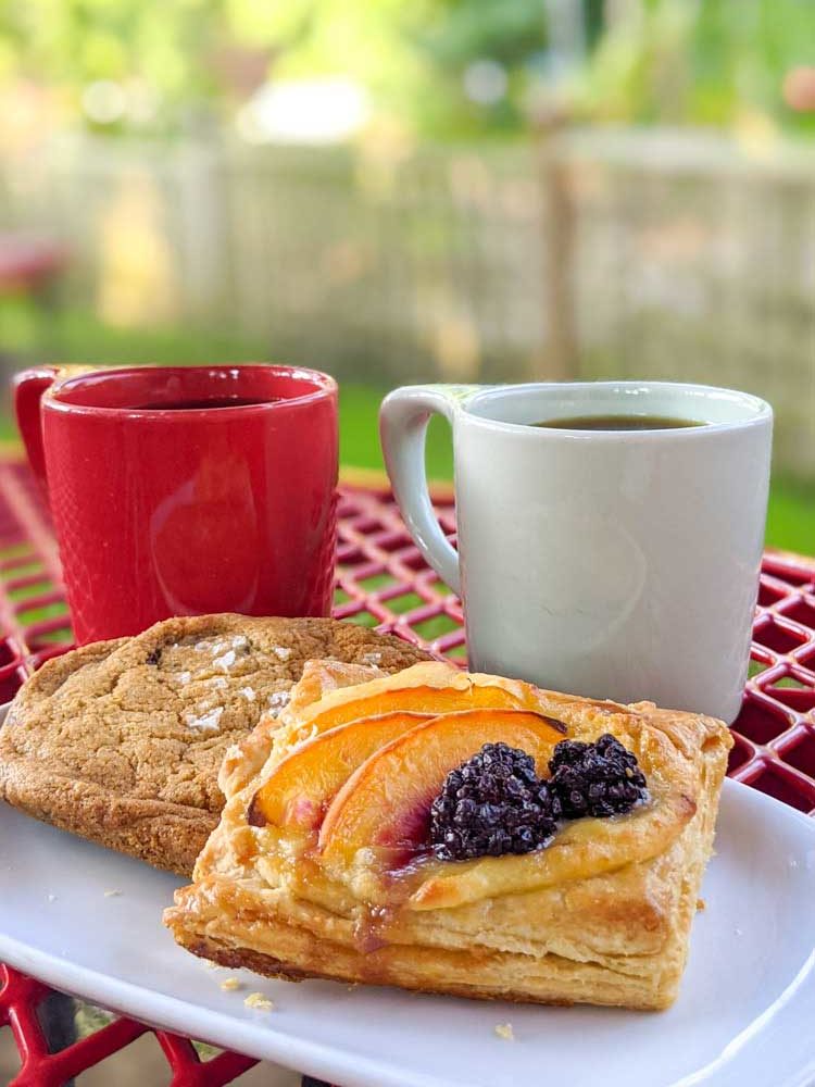 Pastries and coffee on an outdoor table at Liberty House Cafe