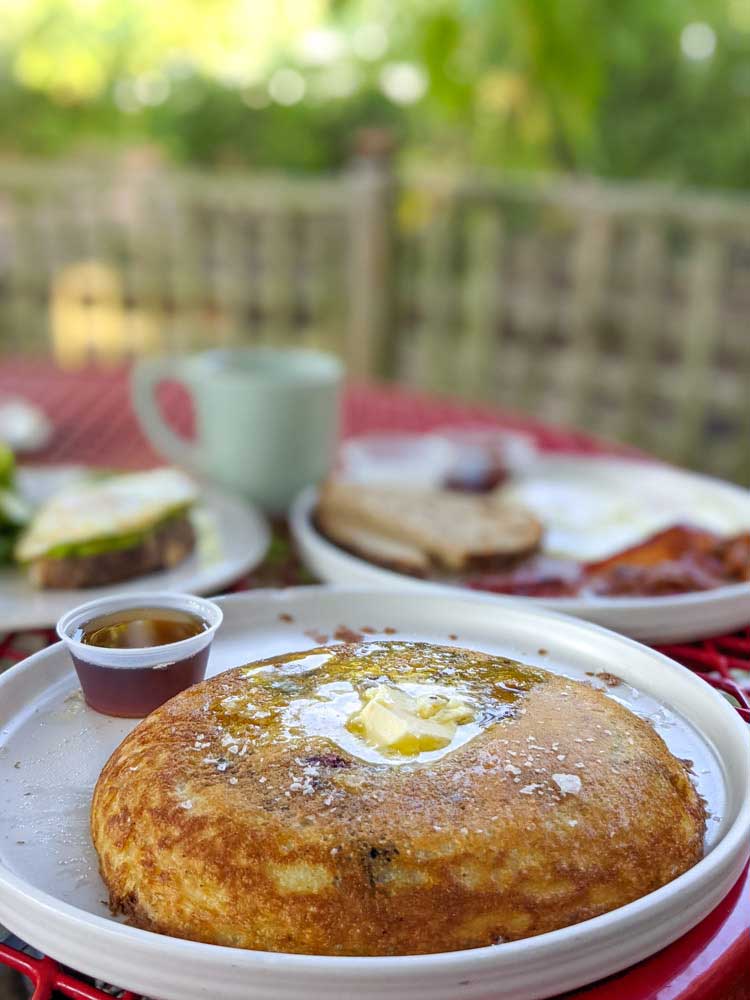 Blueberry sourdough pancake with a side of syrup