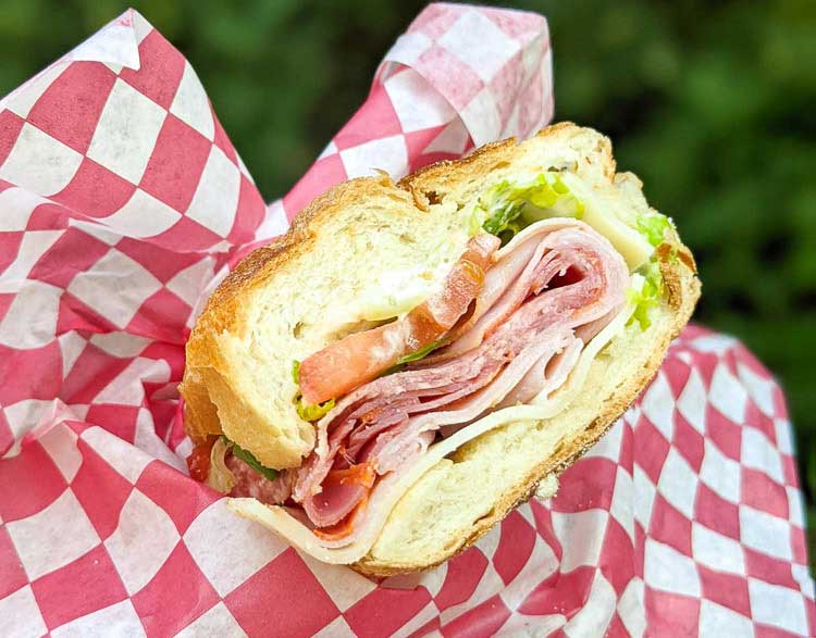 Italian sub sandwich with tomatoes and lettuce from Montford Deli