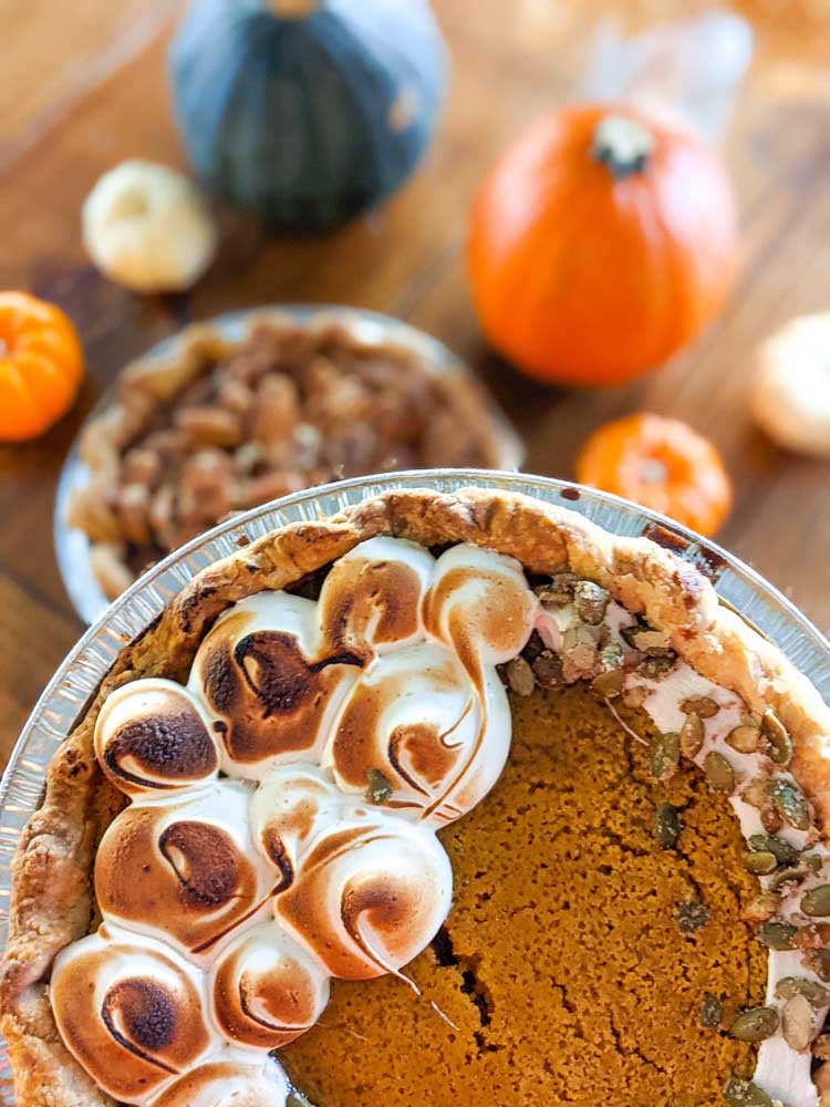 Pumpkin pie with brown sugar meringue and pepitas sprinkled on top