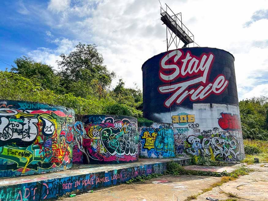 Stay True silo mural next to grafitti