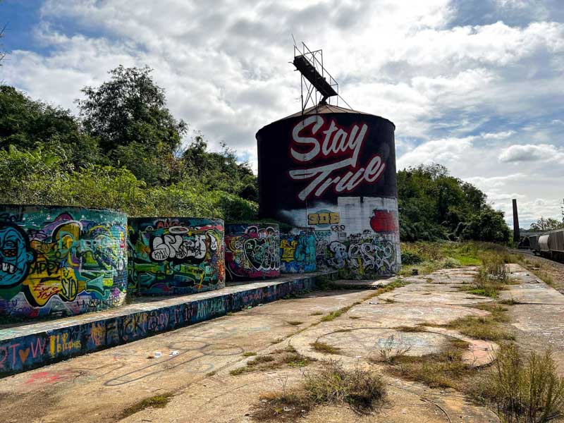 Stay True silo mural and grafitti next to a train tracks in the River Arts District