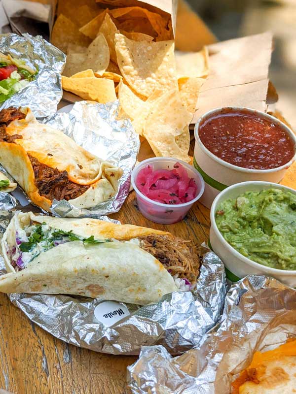 Lunch spread of tacos, guacamole and salsa from Taco Billy