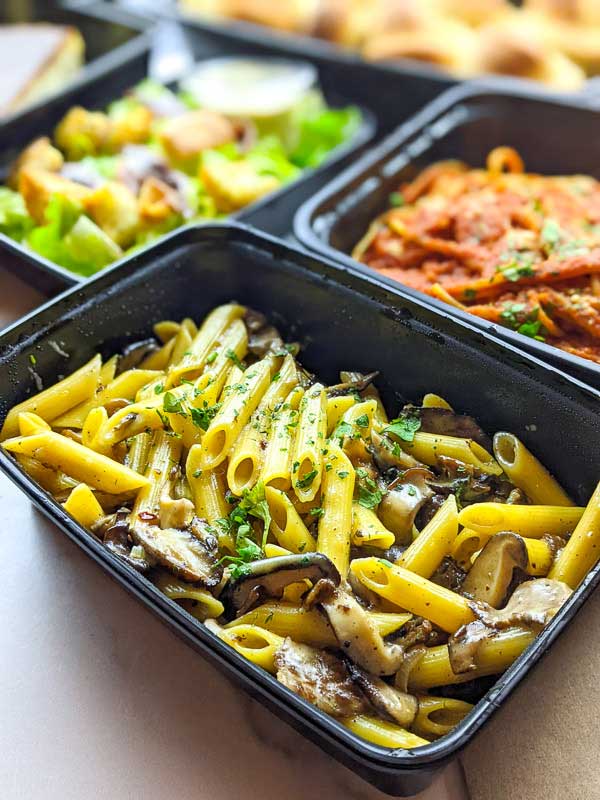 Pasta Al Funghi in a takeout container from Vinnie's in Asheville