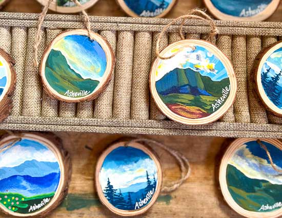 Hand painted ornaments with mountains and sky depicting Asheville NC