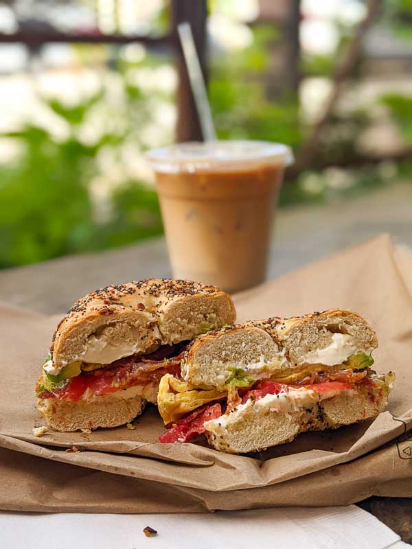 Breakfast sandwich from Tiger Bay Cafe in West Asheville with an iced latte from BattleCat Coffee in the background