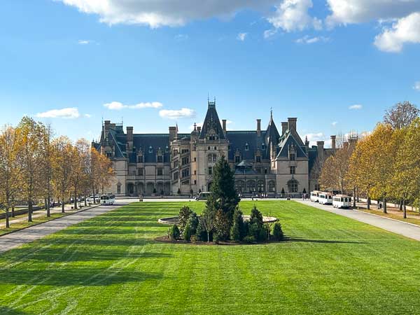 Exterior of the Biltmore House with Christmas trees on the lawn