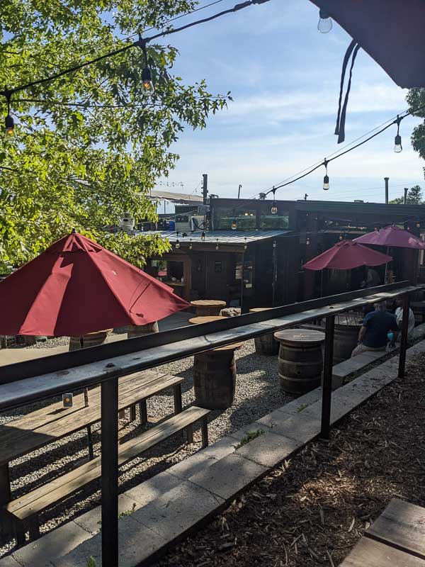 Burial Beer exterior with picnic tables and umbrellas