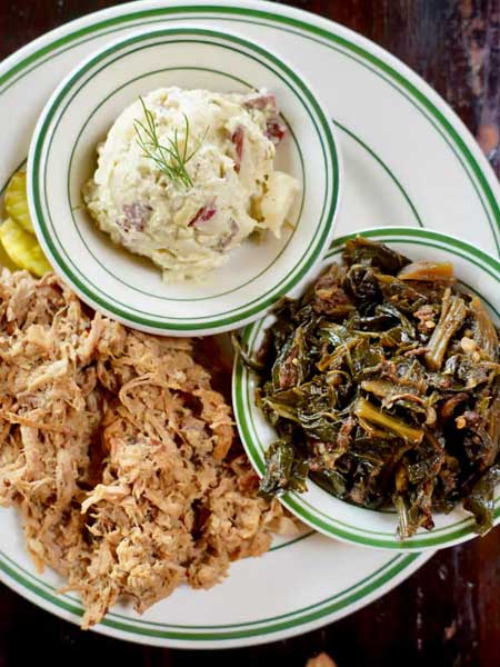 Whole hog BBQ plate with collard greens and potato salad from Buxton Hall BBQ.