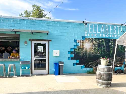 Exterior of Cellarest Beer Project in West Asheville showing a mural on a brick building