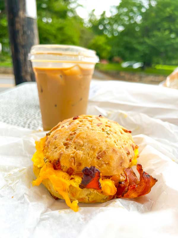 Bacon, egg and cheese biscuit from City Bakery in Asheville with an iced latte in the background