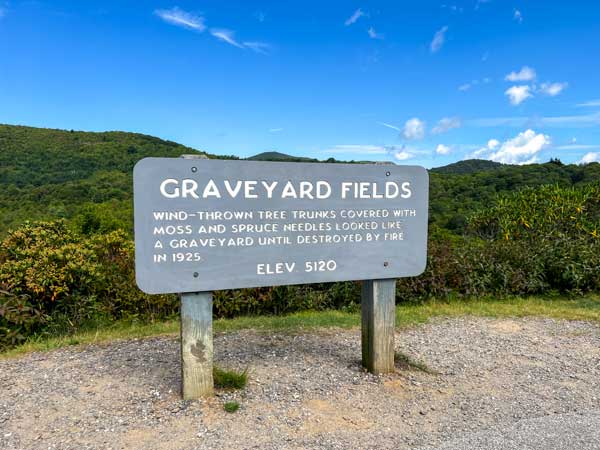 Graveyard Fields sign on Blue Ridge Parkway overlook parking lot.