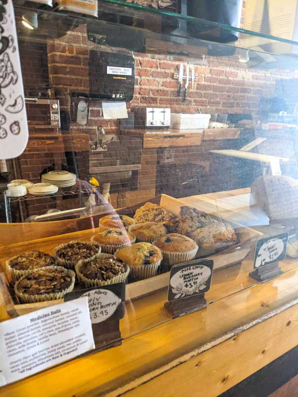 Bakery display case at High Five downtown Asheville showing various muffins for sale