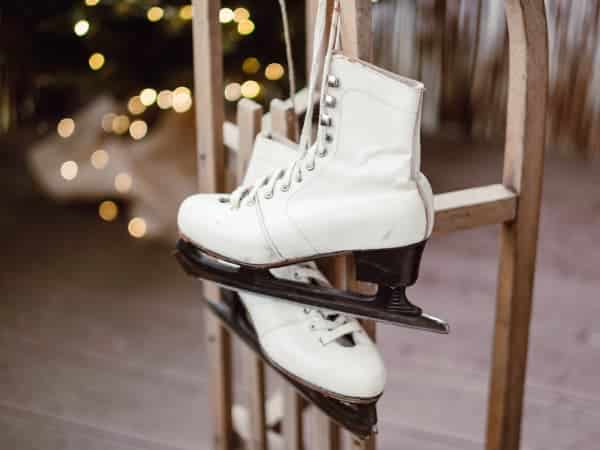 ice-skates-hanging-twinkle-lights Twinkle lights in the background of ice skates hanging together