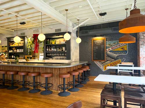 Interior of La Bodega by Curate in downtown Asheville, showing the bar and seating