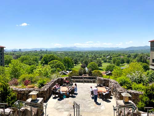 Summer view of downtown Asheville and the Blue Ridge Mountains from the back deck of the Omni Grove Park Inn