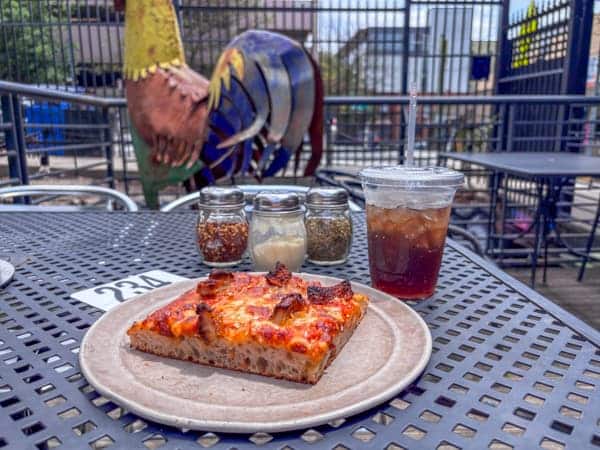 Pizza slice and coke from Birdie's in downtown Asheville