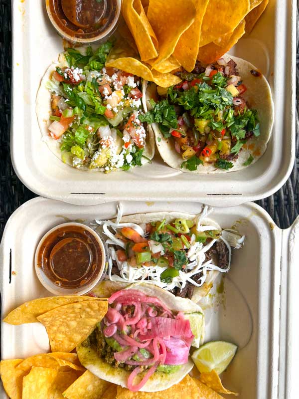 takeout container with tacos, chips and salsa from Taco Temple