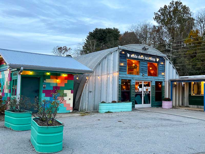 Exterior of white duck taco shop in Asheville on the French Broad